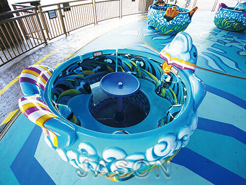 spinning and lifting teacup amusement ride